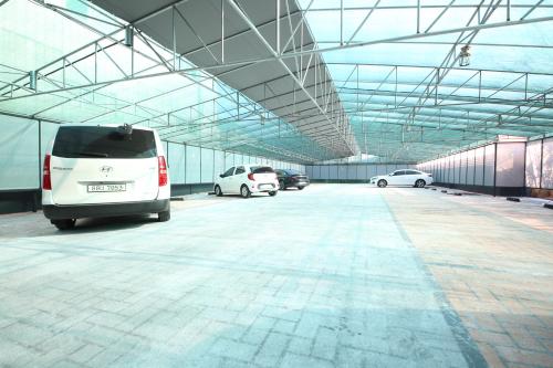 a large parking garage with cars parked in it at Den Basta Hotel in Busan