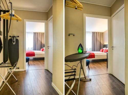 a room with two beds and a table with a laptop at Best Western Hotel Savoy in Karlstad