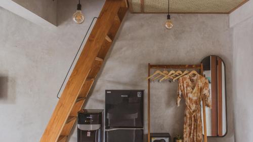 a staircase in a room with a dress hanging on it at Little Ripper Boutique Lofts in Tanah Lot