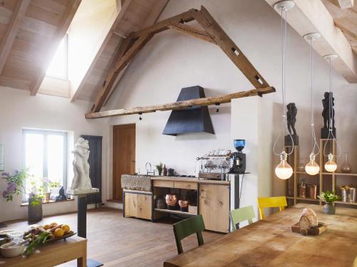 a kitchen with a wooden table in a room at Herzkammer (chamber of the heart) in Kandern