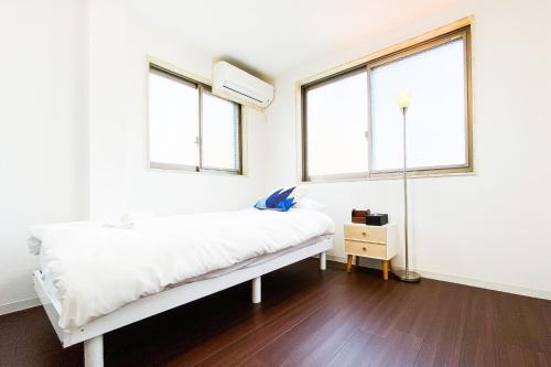 Postel nebo postele na pokoji v ubytování Yahiro 4-chome House 2F,3F
