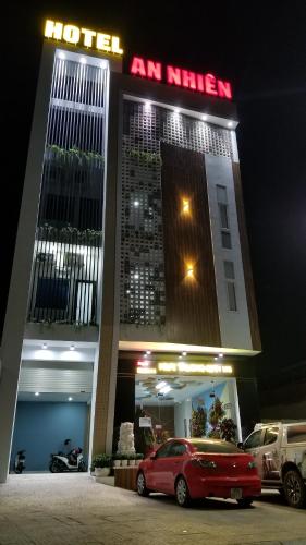 a hotel with a car parked in front of it at An Nhiên Hotel in Tây Ninh