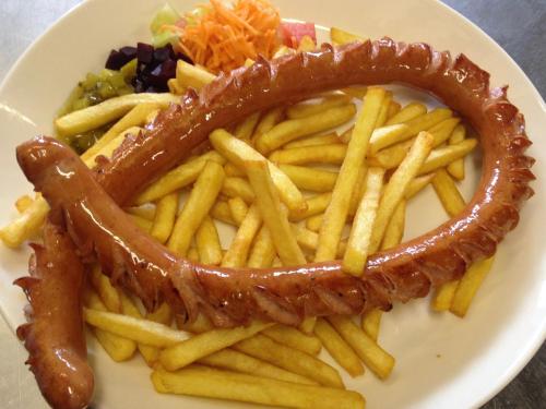 a plate of french fries with a fish stick at Käyrämön Keidas in Tiainen