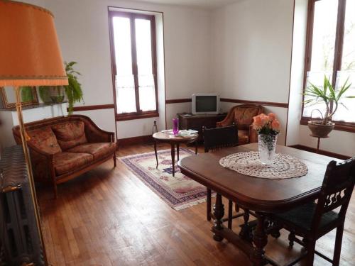 a living room with a table and chairs at Gîte Meublé in Anost