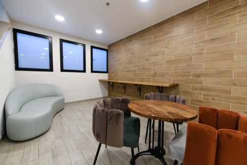 a living room filled with furniture and a large window at HI - Bnei Dan - Tel Aviv Hostel in Tel Aviv