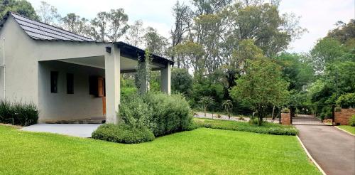 a small white house with a green lawn at Haggards on Hilldrop in Newcastle