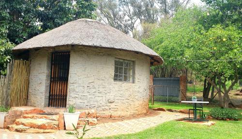 a small stone building with a grass roof at Haggards on Hilldrop in Newcastle