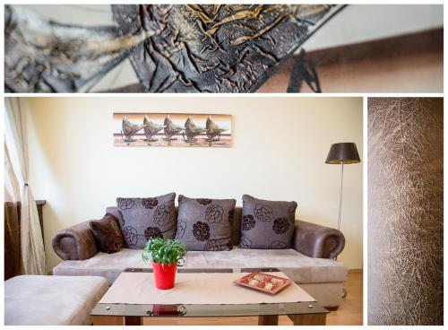 a living room with a couch and a table at Arpad Bridge Apartments in Budapest