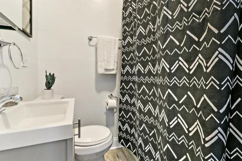 a bathroom with a black and white patterned shower curtain at Cool 2BR Apartment close to Fun City - Grace 2 in Chicago