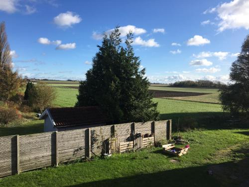 a wooden fence in the middle of a field at Hotell Vellingebacken in Vellinge
