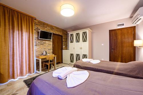 una camera d'albergo con due letti e una scrivania di Antique Boutique Hotel a Pavel Banya