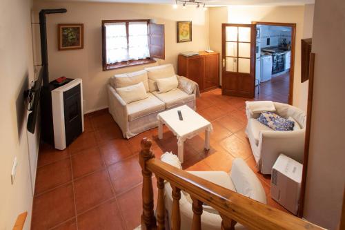 a living room with a couch and a table at Casa Güela Megustarural in Llanes