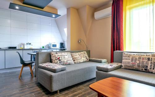 a living room with a couch and a table at Thermal Panzió Sárvár in Sárvár