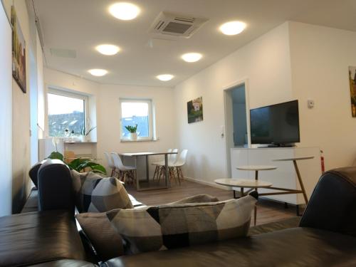 a living room with a couch and a table at Strietpartment - 2 Schlafzimmer, viel Raum und Ruhe in Aschaffenburg