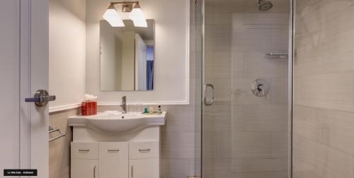 a bathroom with a sink and a shower at Villa Italia South Beach in Miami Beach