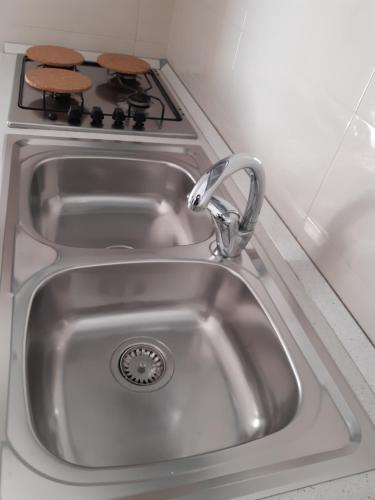 a sink in a kitchen with a stove at San Marco Beach App Libeccio in Agropoli