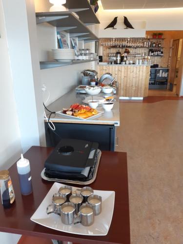 a kitchen with a counter with a laptop on a table at Hótel Flókalundur in Brjánslækur