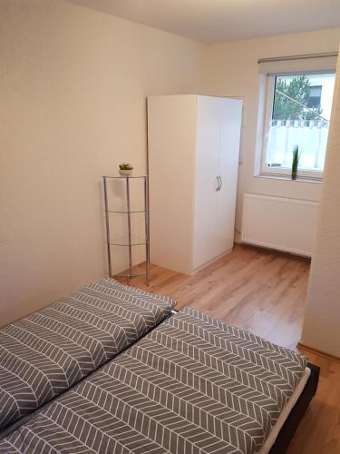 1 dormitorio con cama, armario y ventana en 30 qm Apartment super zentral in Melsungen, en Melsungen