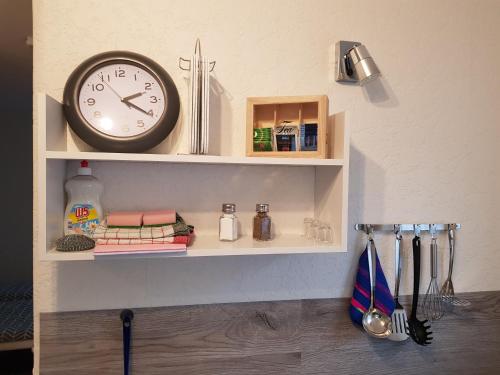 a shelf with a clock on top of it at 30 qm Apartment super zentral in Melsungen in Melsungen