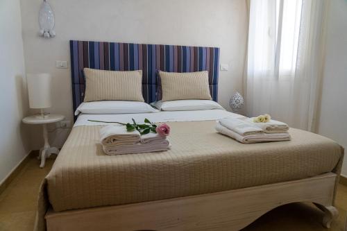 a bedroom with a bed with towels on it at Agriturismo Residenza Gemma in Porto Cesareo
