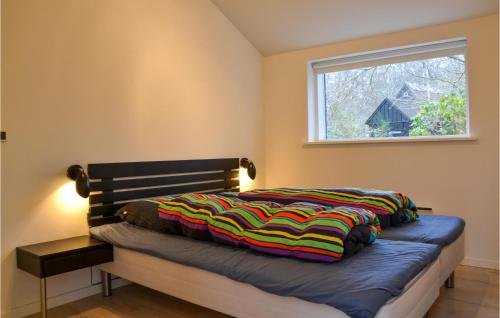 a bed in a room with a window at Amazing Home In Grsted With Kitchen in Græsted