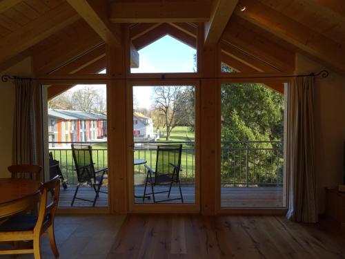 a screened in porch with sliding glass doors at Ferienwohnung Molopark im Haus Ecker in Murnau am Staffelsee