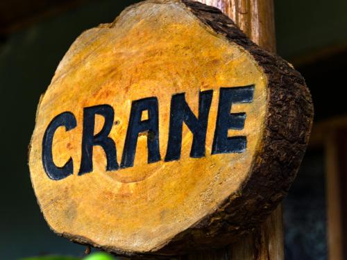 a sign that saysarma on a wooden pole at Karungi Camp in Rubuguli
