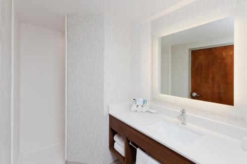 a bathroom with a sink and a mirror at Holiday Inn Express Hotel & Suites Montgomery Boyd-Cooper Parkway by IHG in Montgomery