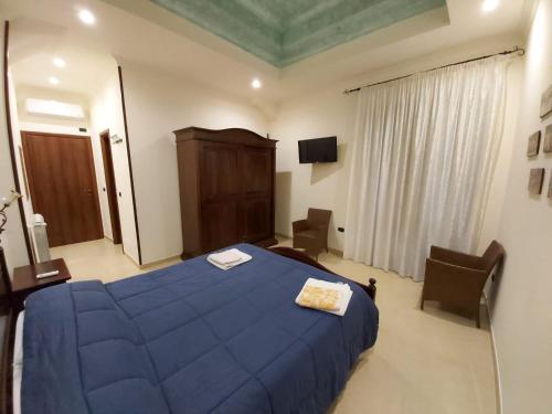 Ένα ή περισσότερα κρεβάτια σε δωμάτιο στο B&B il Baglio