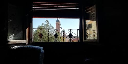 a view of a clock tower from a window at Casa Aljez in Calatayud