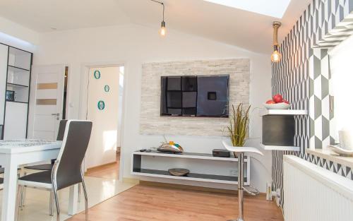 a living room with a table and a tv at EASY RENT Apartments - LOFT, Centrum 24h Check-in in Lublin