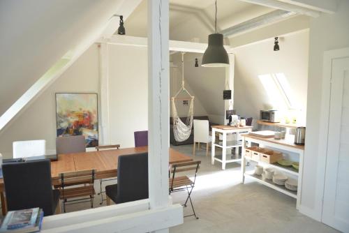 a dining room and kitchen with a table and chairs at Five Point Hostel & Apartments in Gdańsk