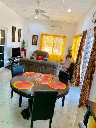 a living room with a table and chairs at Chupaflor - Alexander Luxury & Executive Suites in Belize City