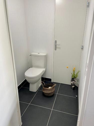 a small bathroom with a toilet and a door at T2 Ajaccio vue mer in Ajaccio