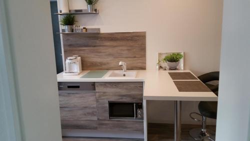 a kitchen with a sink and a counter top at Ferienwohnungen Fuchs in Duisburg