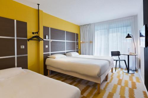 Cama o camas de una habitación en ibis Styles Massy Opéra