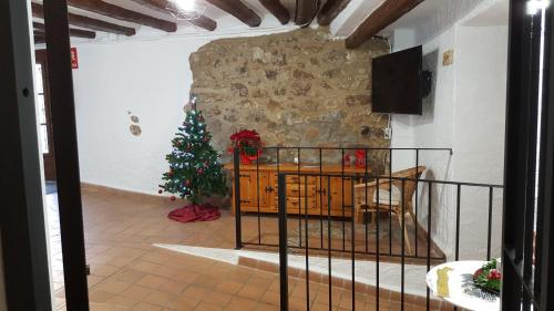 a living room with a christmas tree in a room at espai Abadia in Argentera