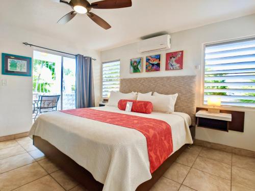 a bedroom with a bed and a ceiling fan at Sand Castle on the Beach - Adults Only in Frederiksted