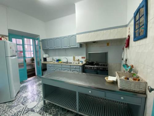 a kitchen with blue cabinets and a blue counter top at Guest House Infante Dom Henrique in Coimbra