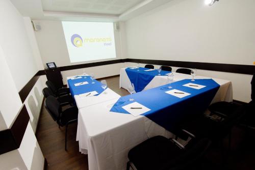 a meeting room with two tables with blue and white table cloth at Hotel Maranata Valledupar in Valledupar
