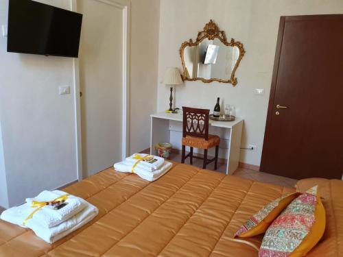 a bedroom with a large bed with towels on it at Liluna in Bologna