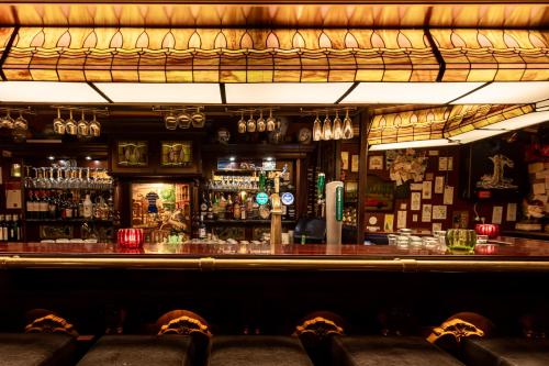 a bar with chairs in front of a bar at De Stobbe hotel & suites in Ruinen