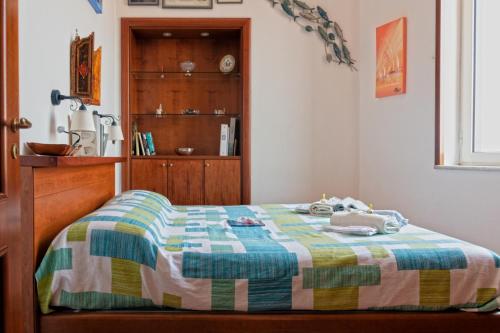 a bedroom with a bed and a wooden cabinet at A wonderful penthouse in Naples in Naples