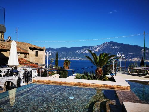 a villa with a swimming pool and a view of the ocean at Locanda San Marco in Torri del Benaco