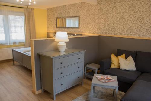 a living room with a couch and a bed at Im alten Rathaus in Bad Liebenstein