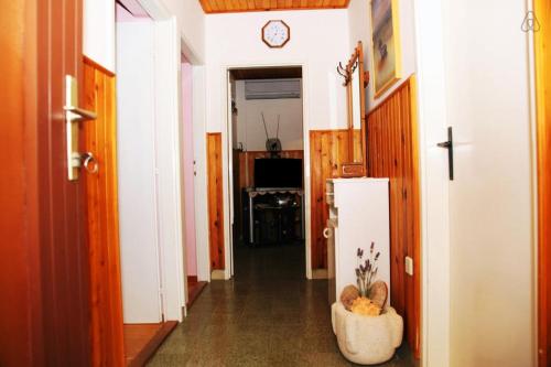 a hallway with a refrigerator in a room at Apartment with Sea View in Prigradica