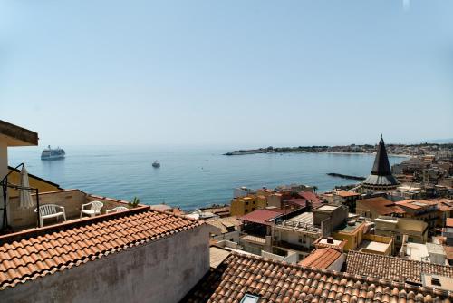 a view of the water from a city with buildings at Nick & Santo's Holiday Homes B&B in Giardini Naxos
