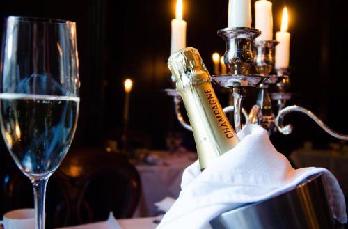 a bottle of wine sitting next to a glass on a table at 23 Mayfield in Edinburgh