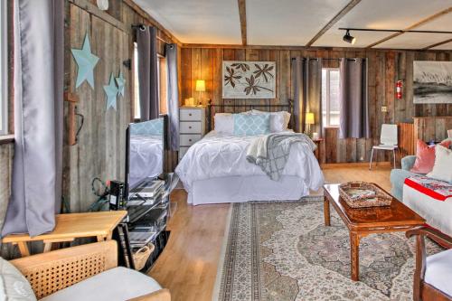 a bedroom with a bed and a couch at Sandy Toes Loft with Ocean Views in Moclips! in Moclips