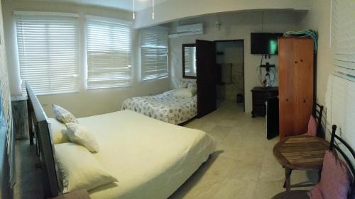 a bedroom with two twin beds and a mirror at Villa Marsana in Aguada
